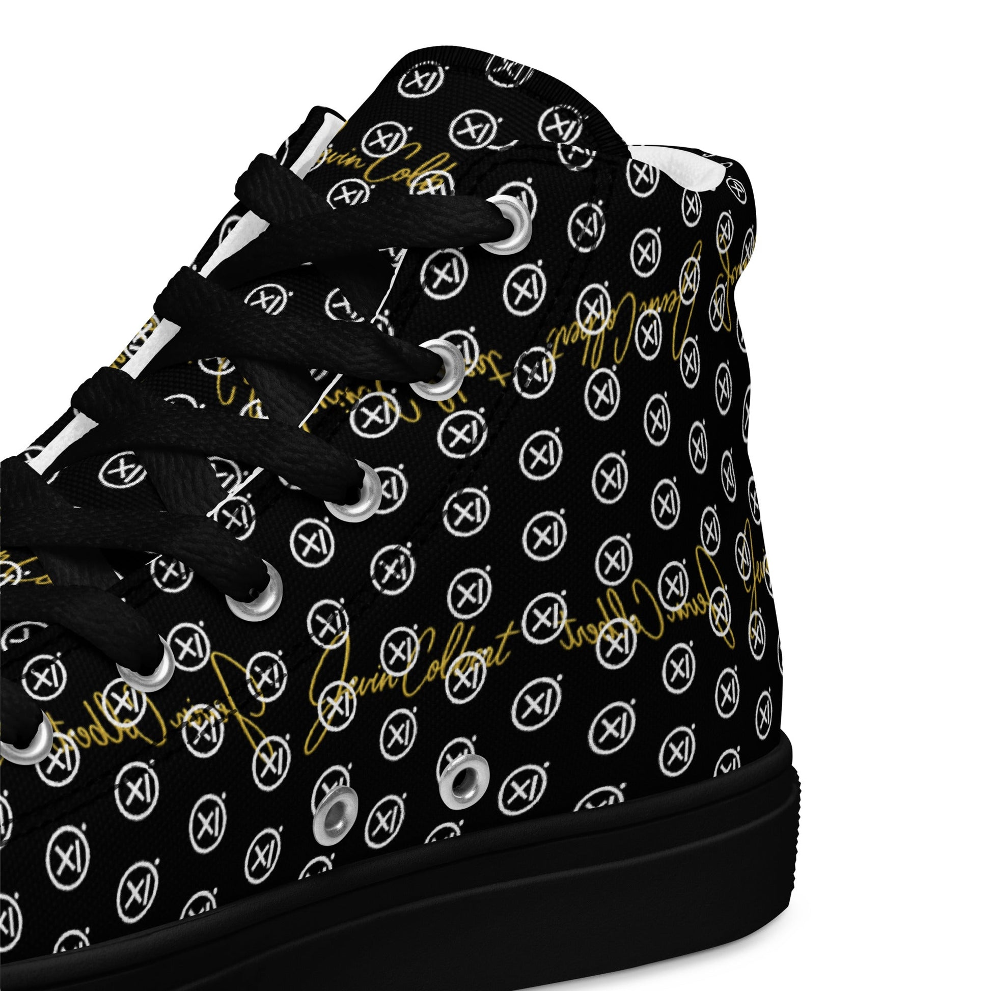 Black high-top sneaker upper close-up showing laces and repeating monogram icons.