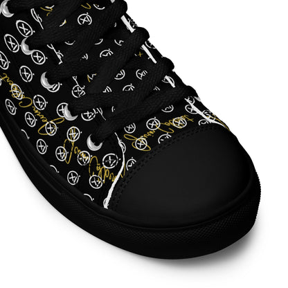 Black high-top sneaker close-up with monogram canvas upper and black rubber toe cap.