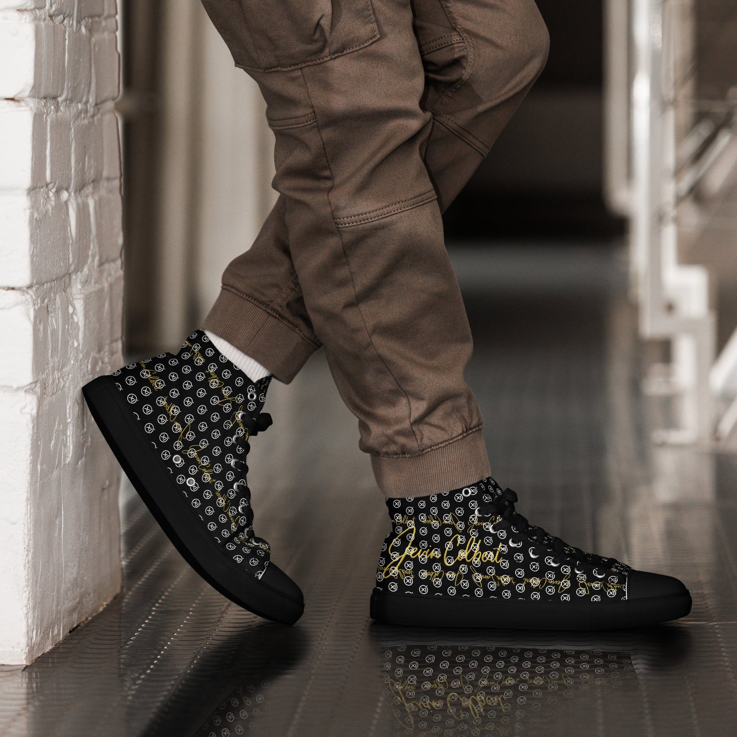 Black high-top canvas sneaker with yellow monogram pattern and white laces