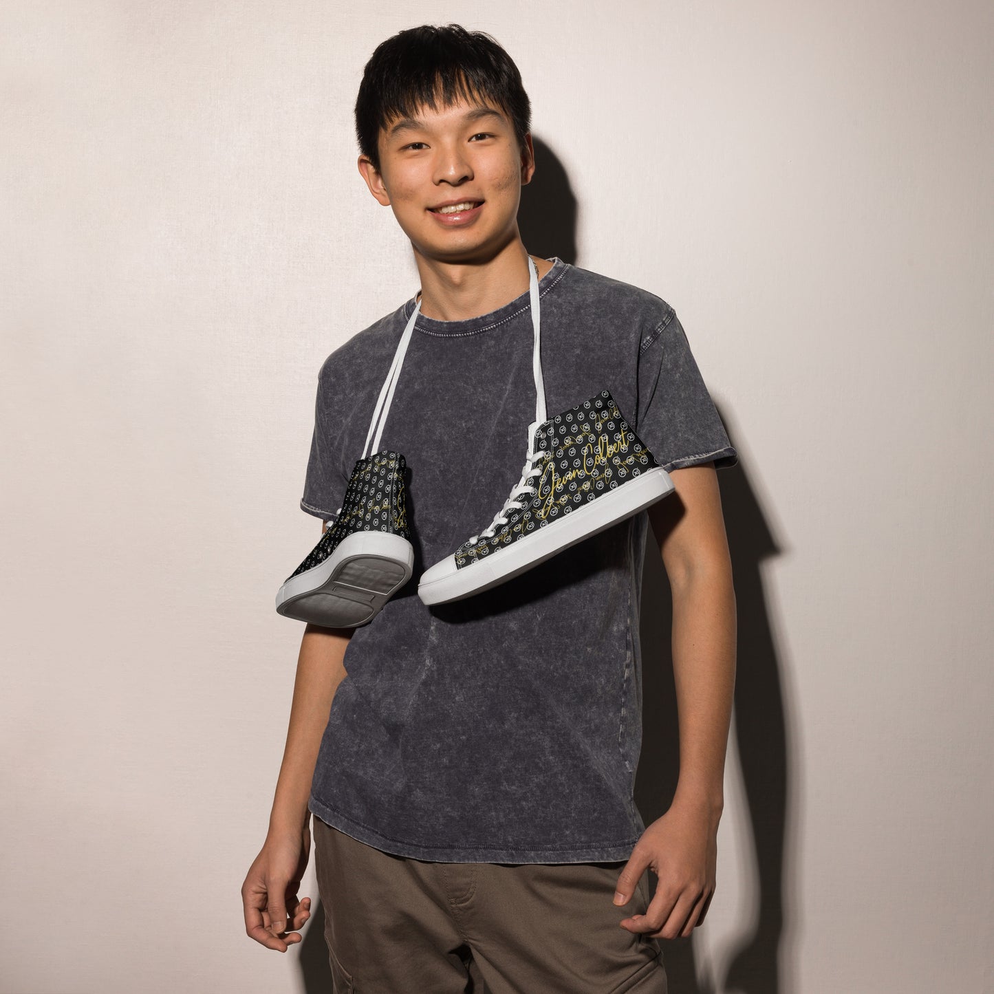 Black high-top canvas sneaker with white laces and monogram pattern on side