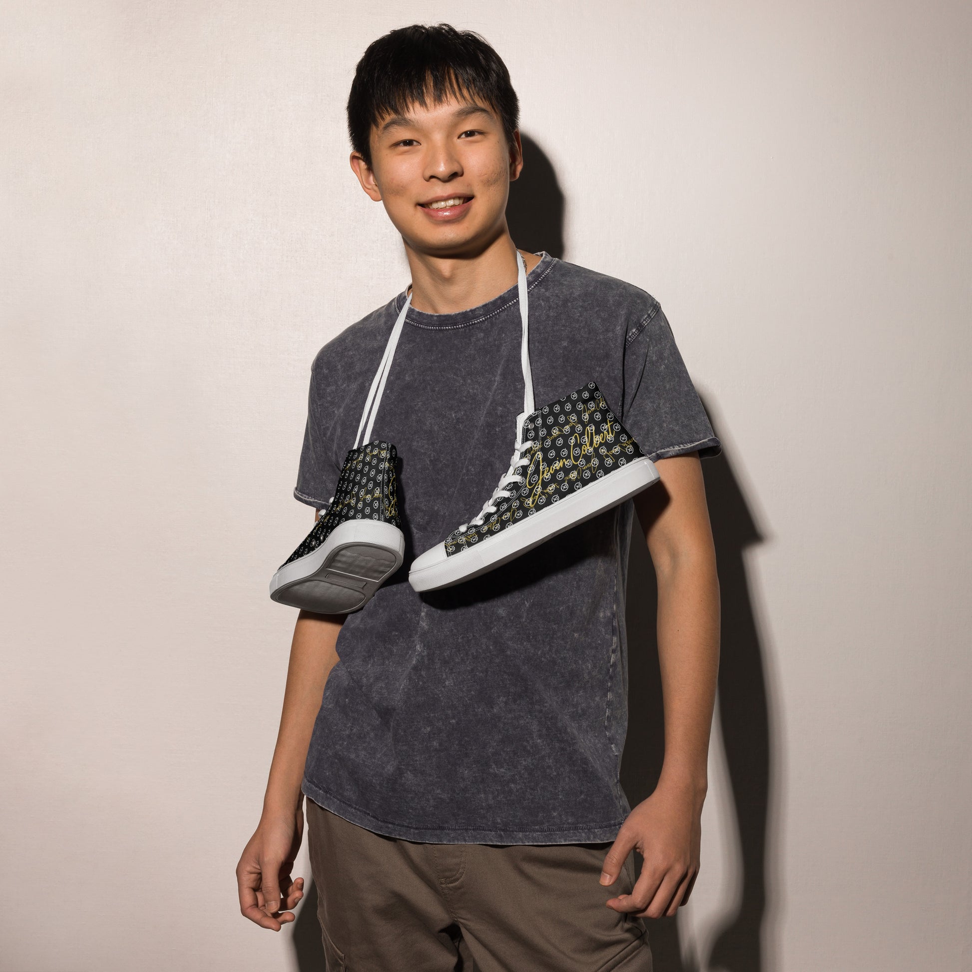 Black high-top canvas sneaker with white laces and monogram pattern on side