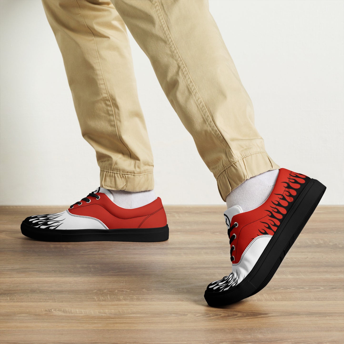 Canvas sneaker front and side view with red upper, white toe, and black flame design