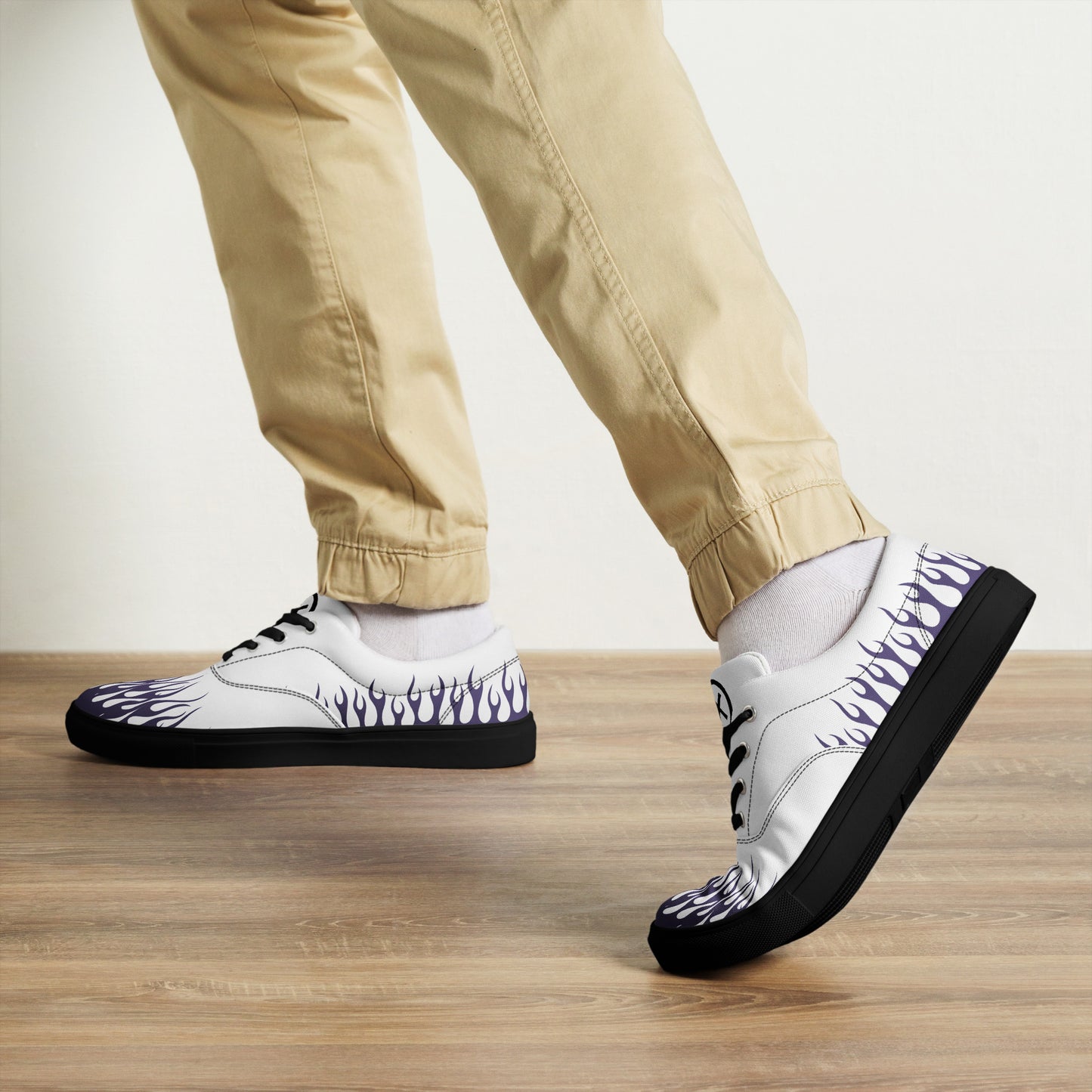 White canvas sneakers with violet flame print, black outsole, black laces, low-top side angle.