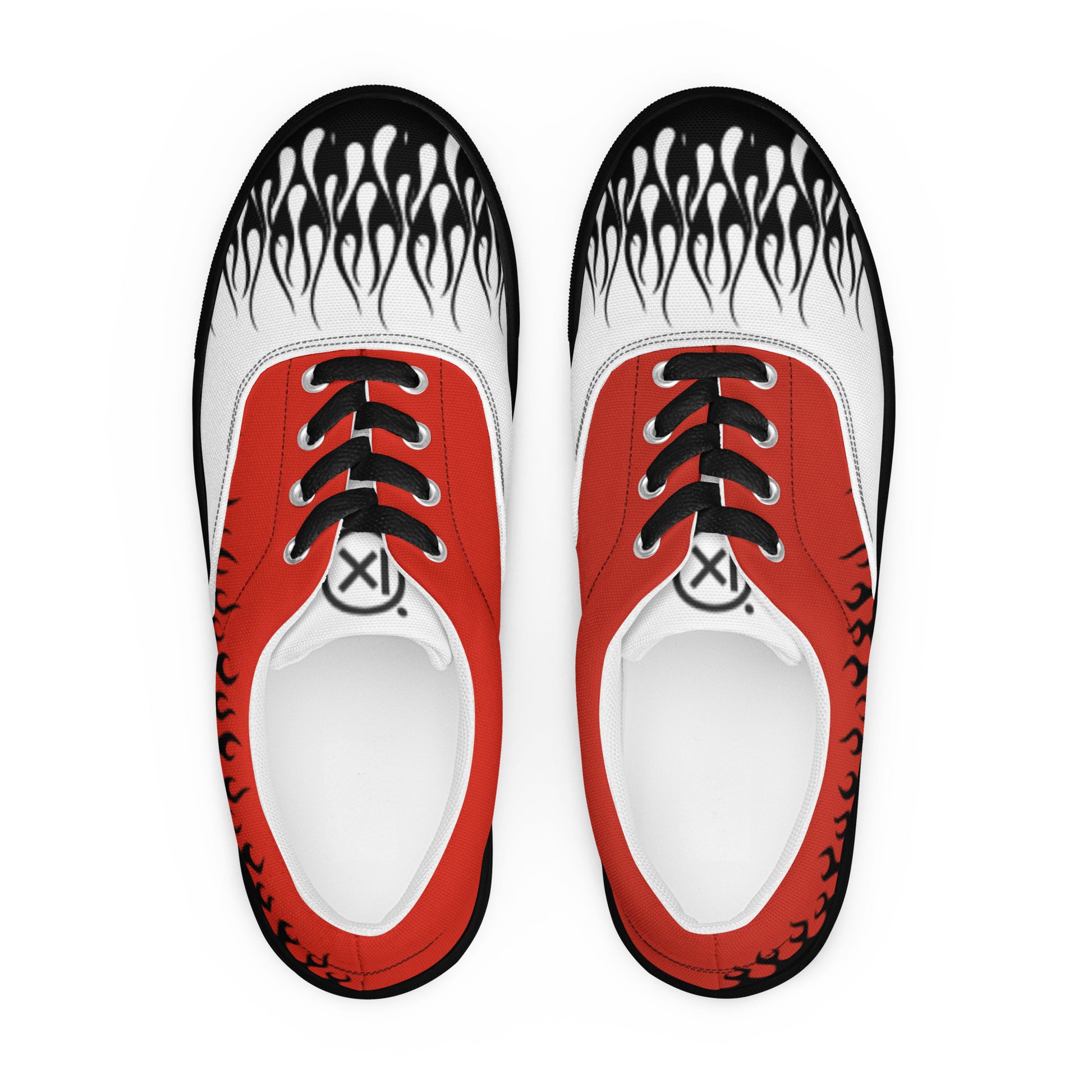 Pair of red canvas sneakers with white flame-print uppers, black laces, and white eyelets