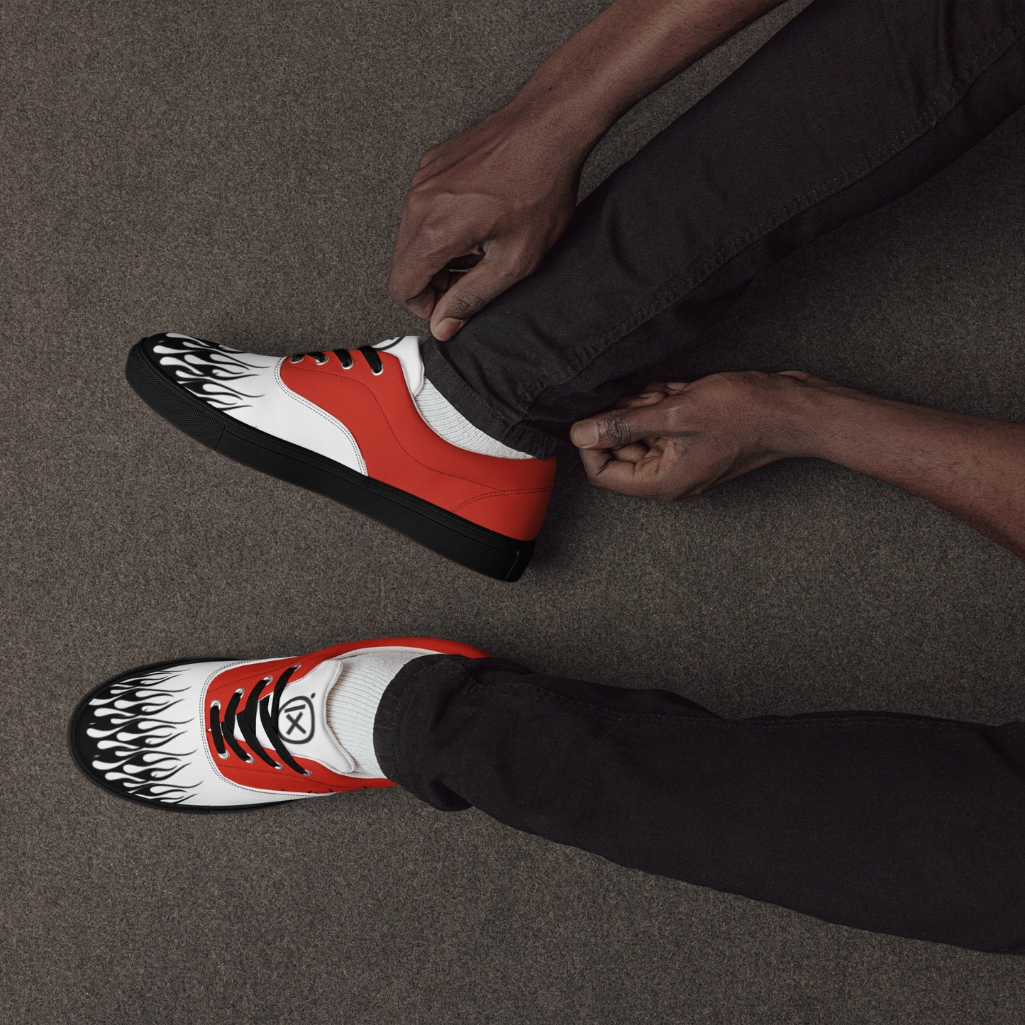 Canvas sneaker in red, white, and black with flame graphic on toe and side