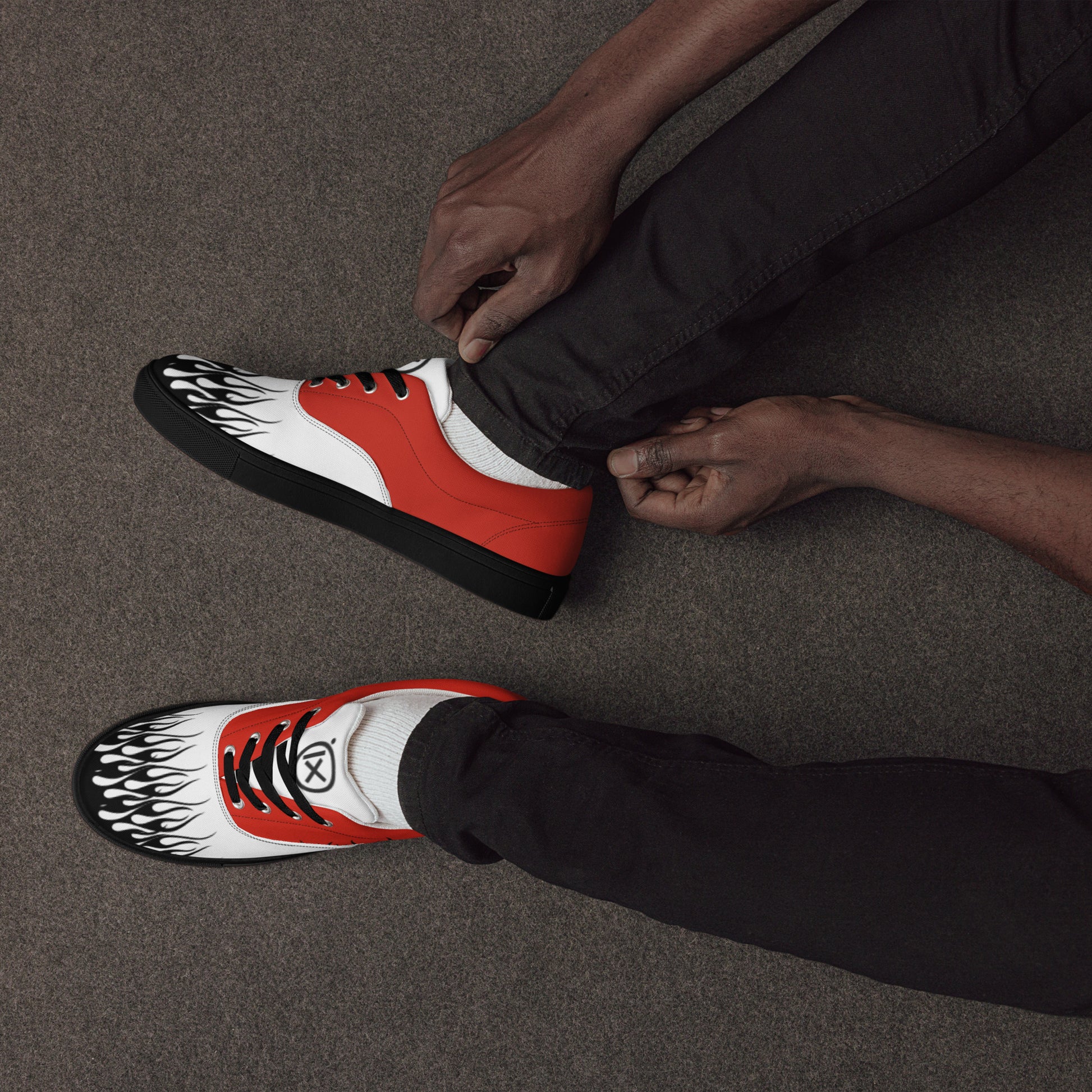 Canvas sneaker in red, white, and black with flame graphic on toe and side