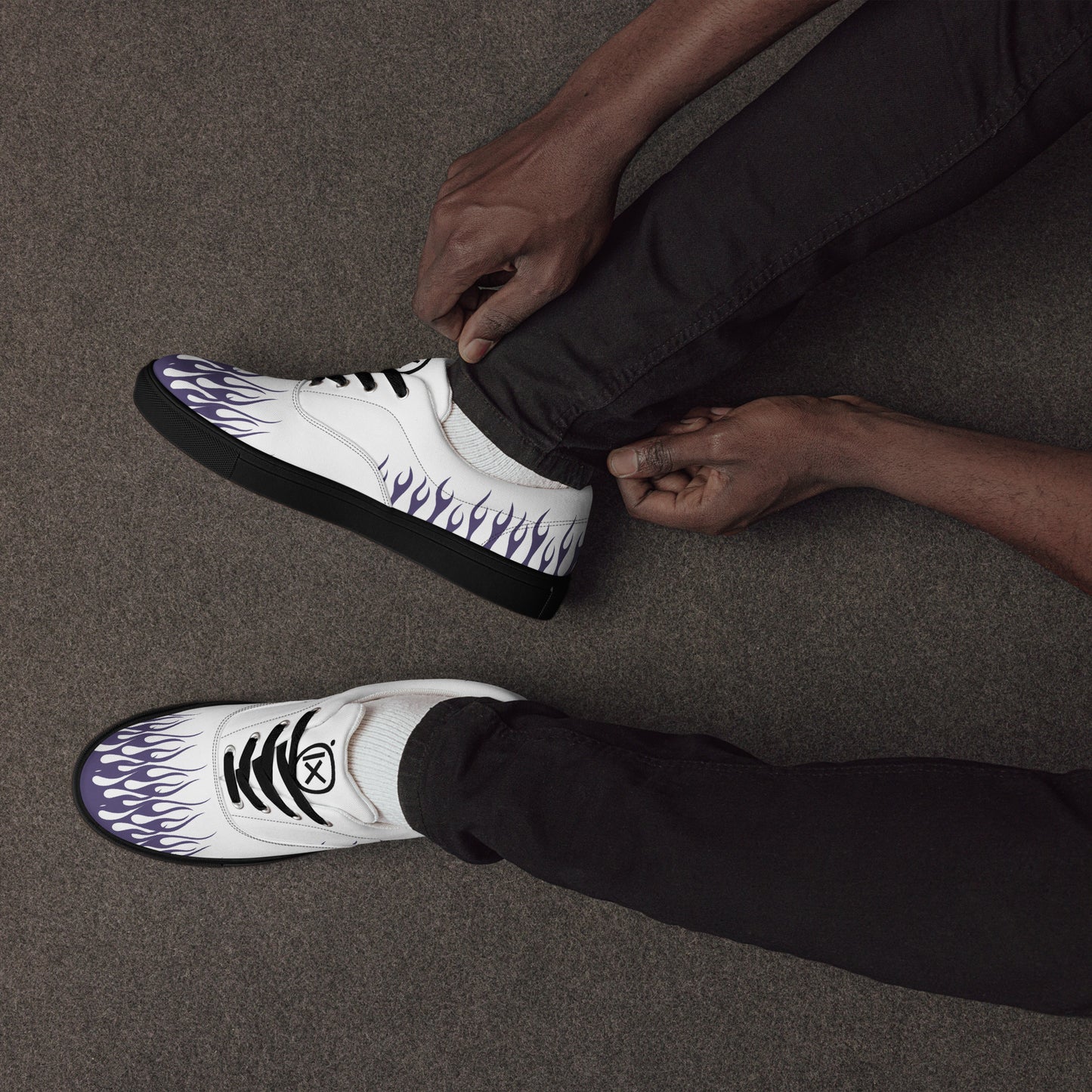 White canvas sneaker with violet flames on side and toe; black laces and sole