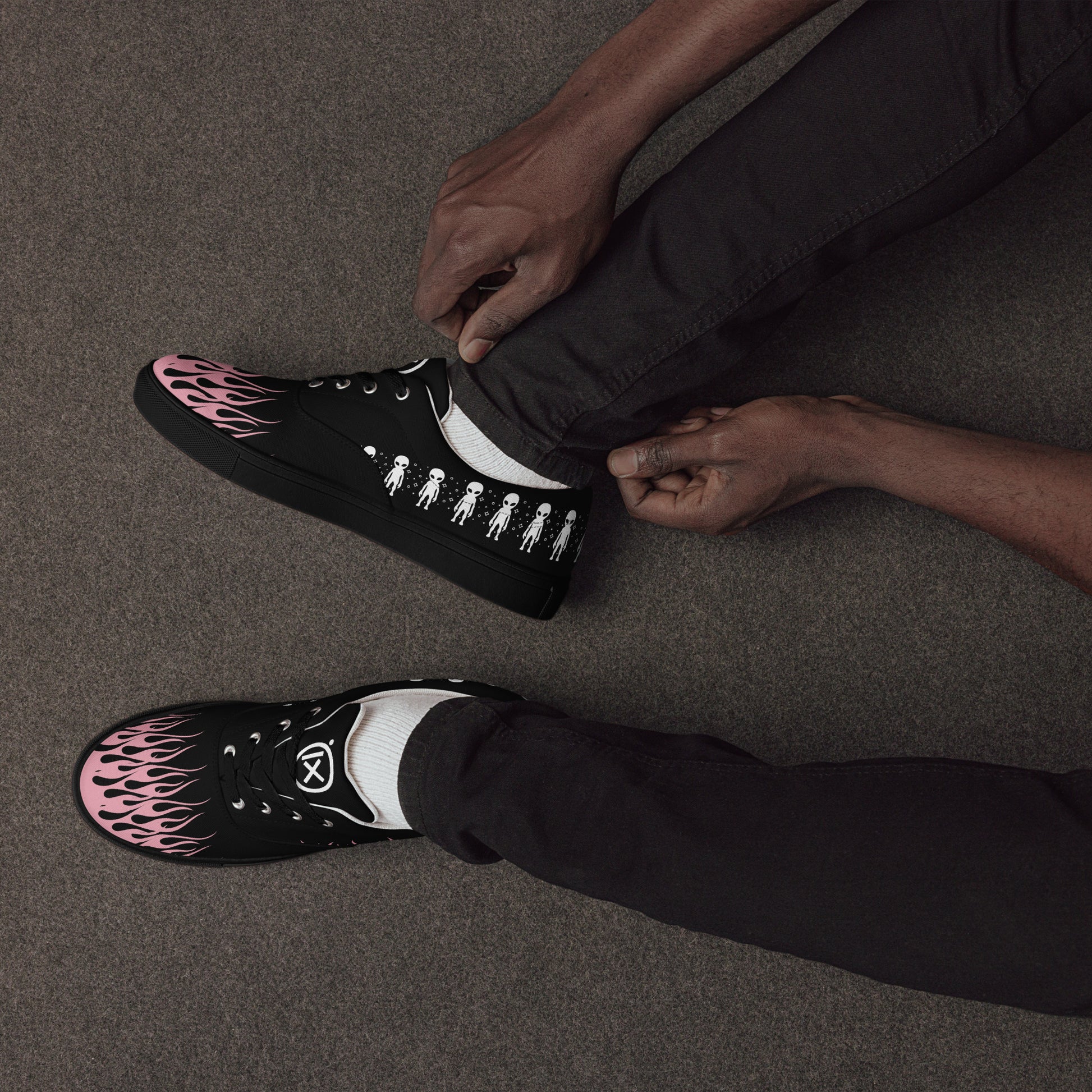 Black canvas sneakers with pink flame toe panel, lace-up front, low rubber sole
