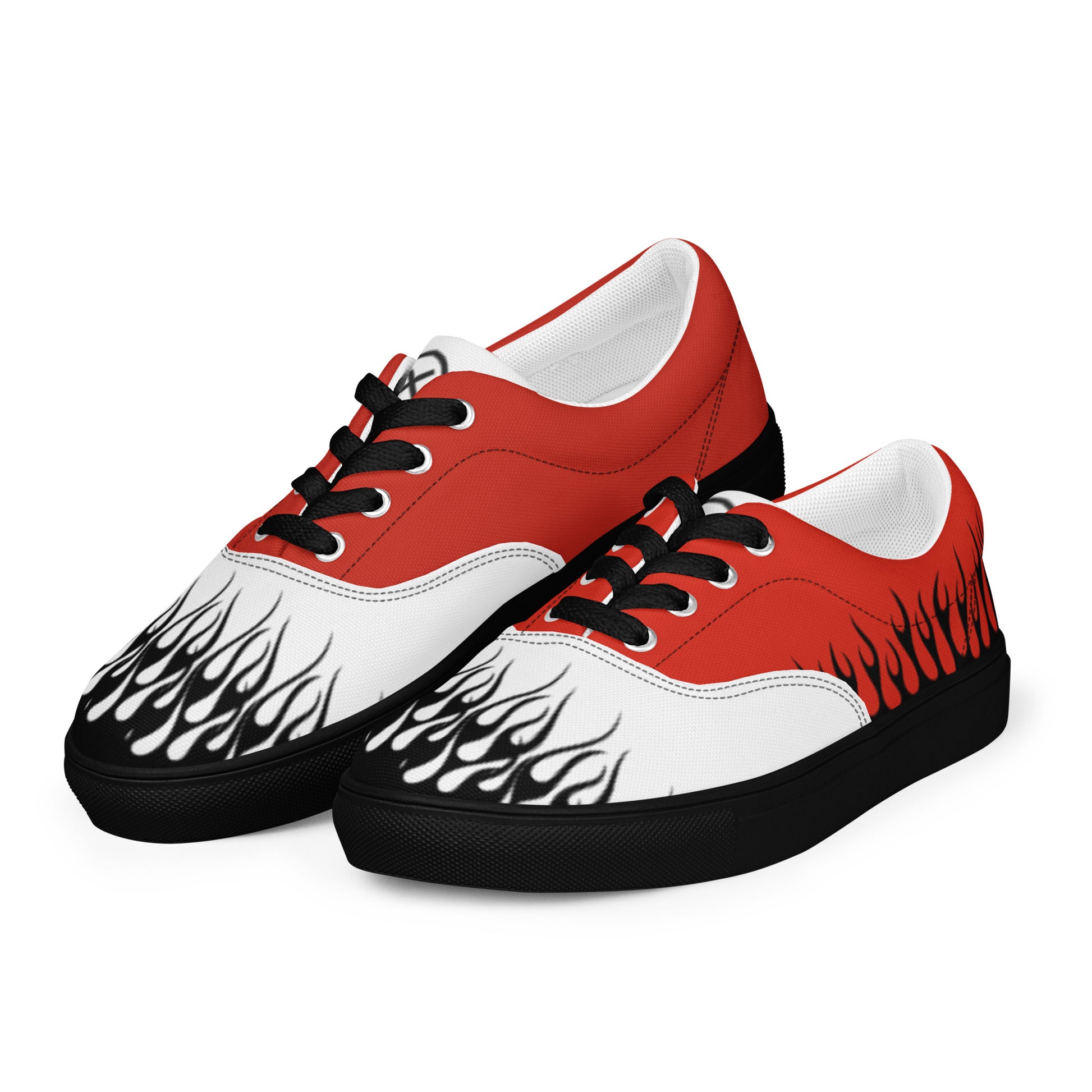 Red and white low-top canvas sneakers with black flame print and black lace eyelets