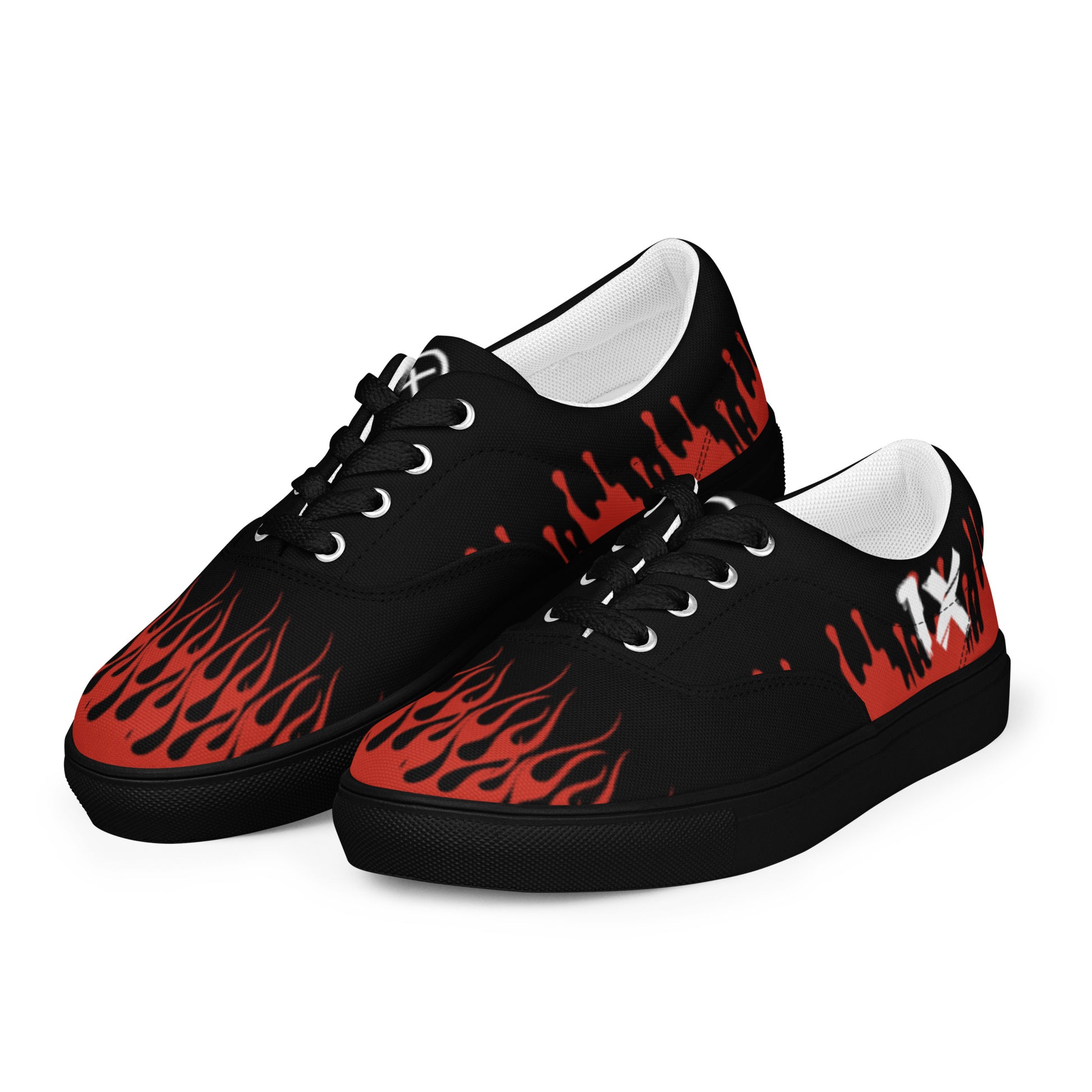 Black low-top canvas sneakers with red flame graphic and white-tinted lining, lace-up.