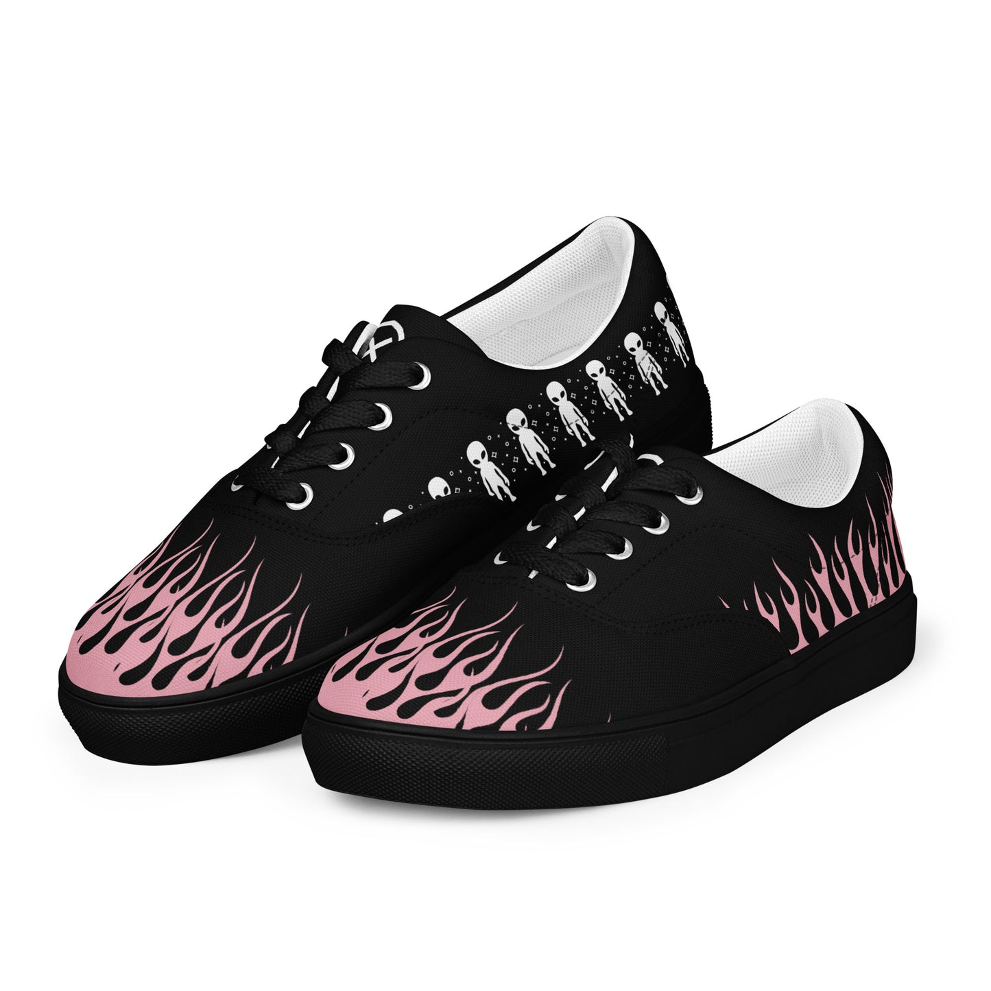 Pair of black canvas lace-up sneakers with pink flame graphics and white soles