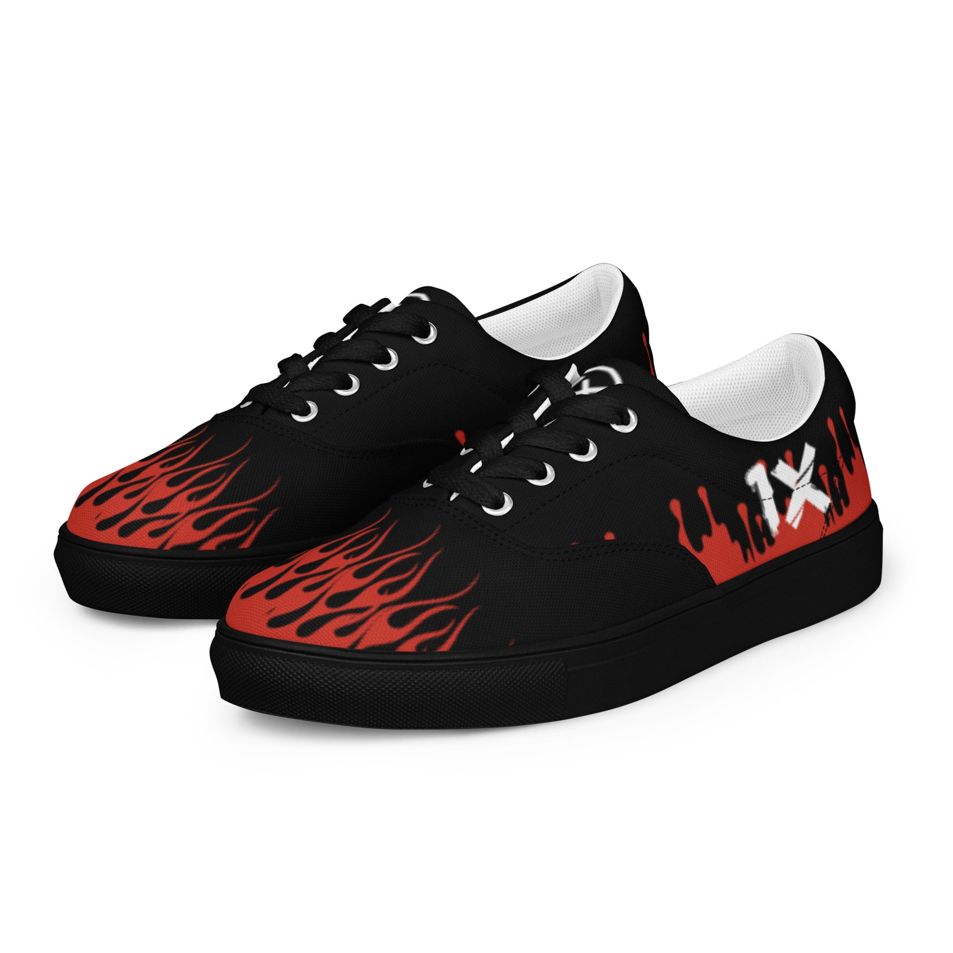 Canvas sneakers pair, black uppers with red flame pattern, white lining and eyelets