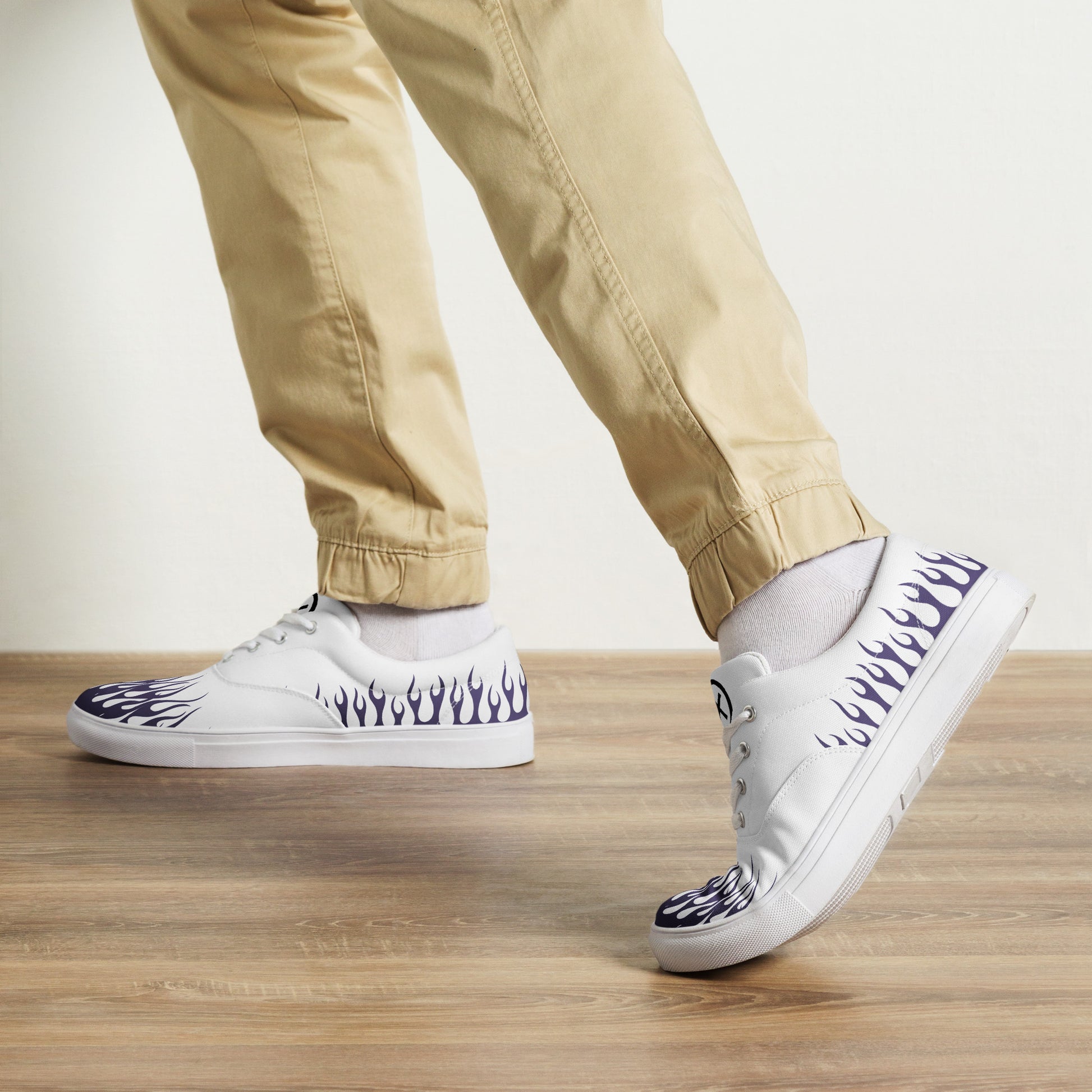 White canvas low-top sneakers with violet flame print and black outsole, lace-up style.