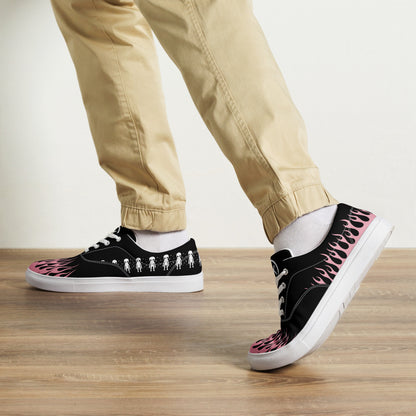 Black canvas sneaker on foot with pink flame side print and white rubber sole