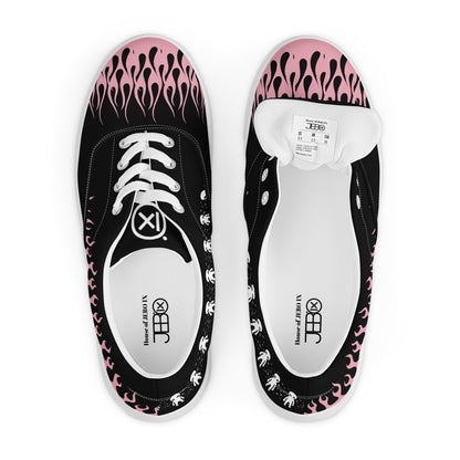 Black canvas sneaker top view with pink flame print and visible tongue label