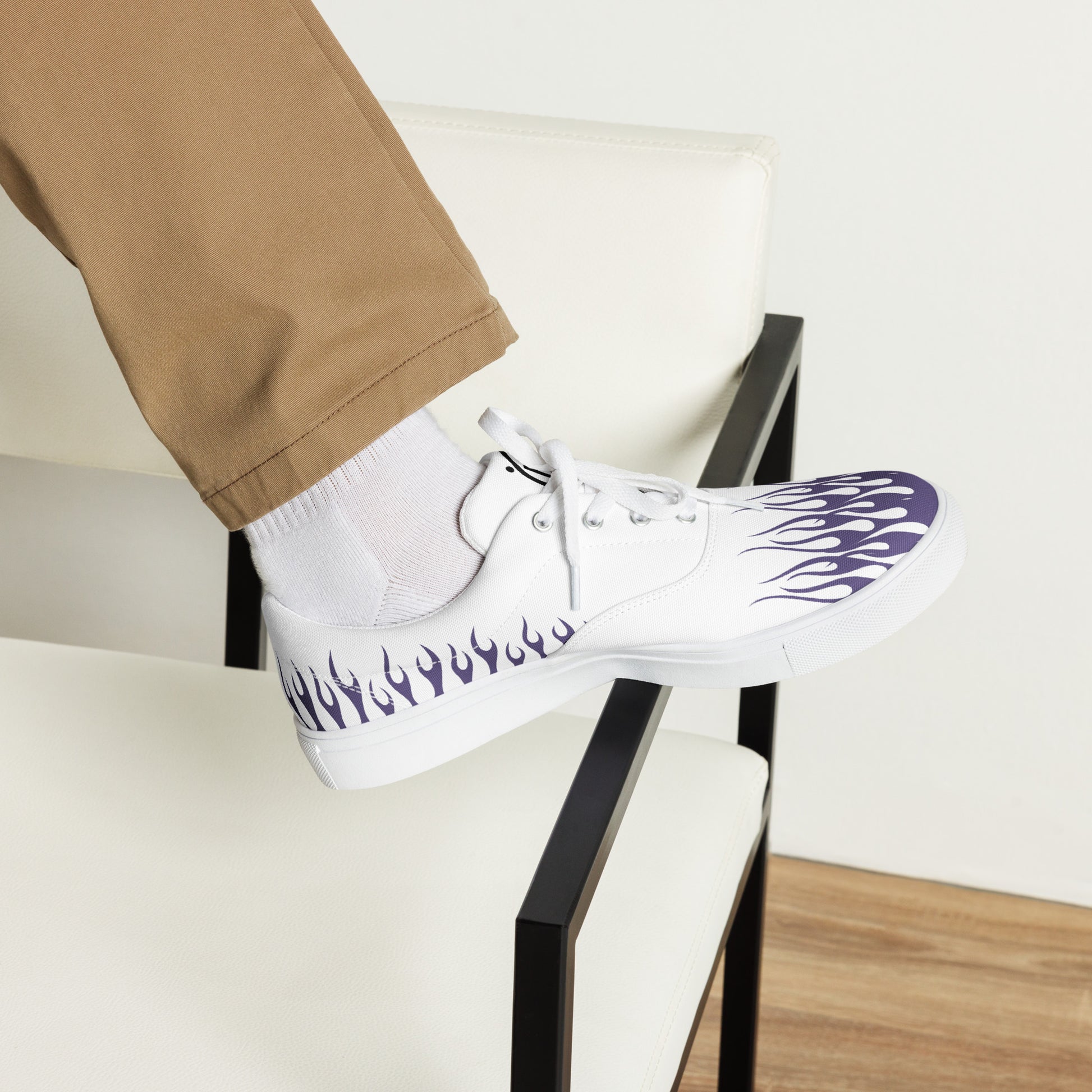White canvas sneaker with violet flame print and black-trimmed sole, lace-up, side view.