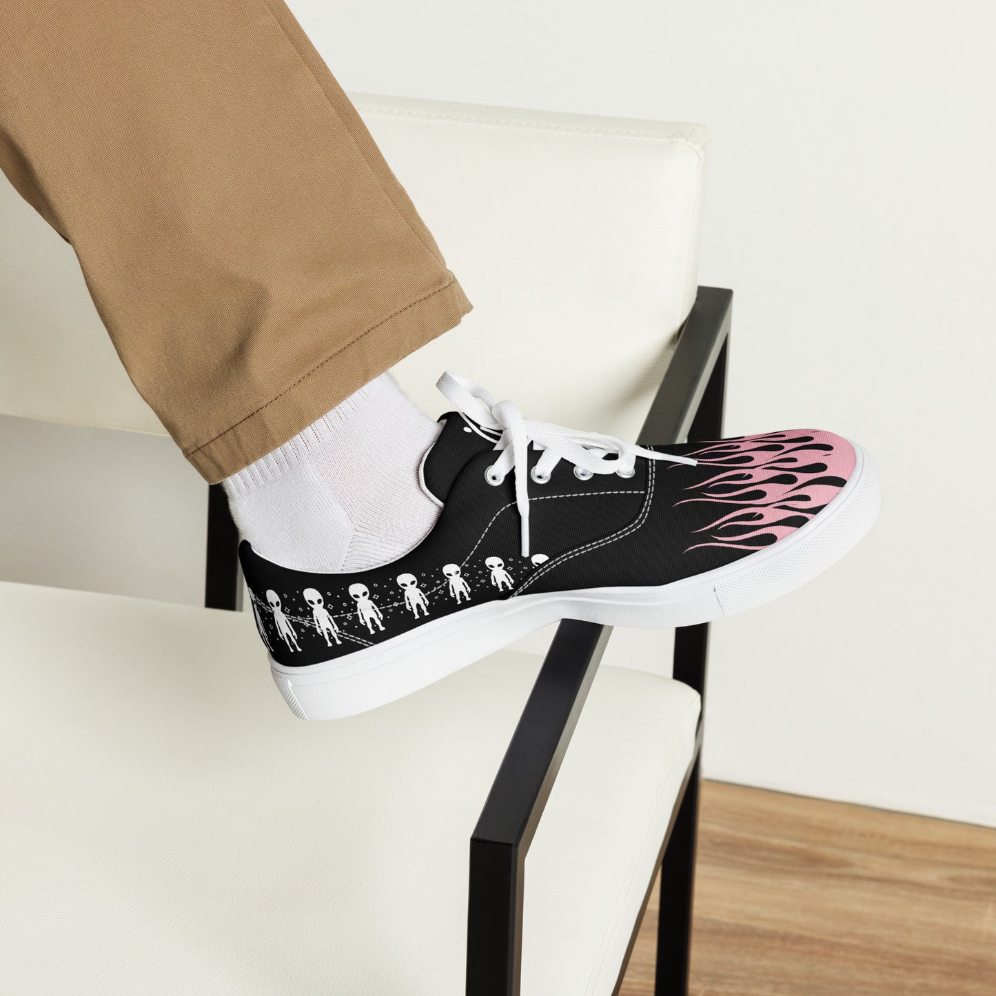 Black canvas sneaker on chair with pink flame side print, lace-up, white sole