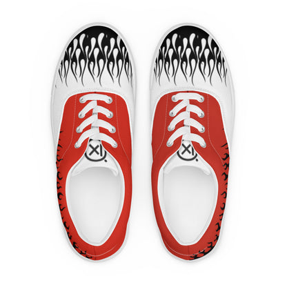 Pair of white-and-red canvas sneakers with flame graphics on the toe and black-striped trim