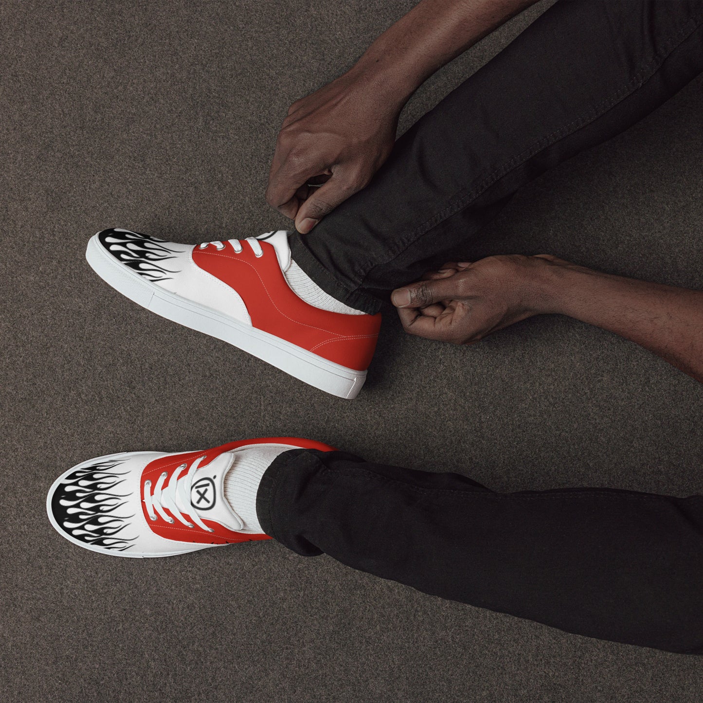 Canvas sneaker red and white with black flame print and black rubber sole, side view