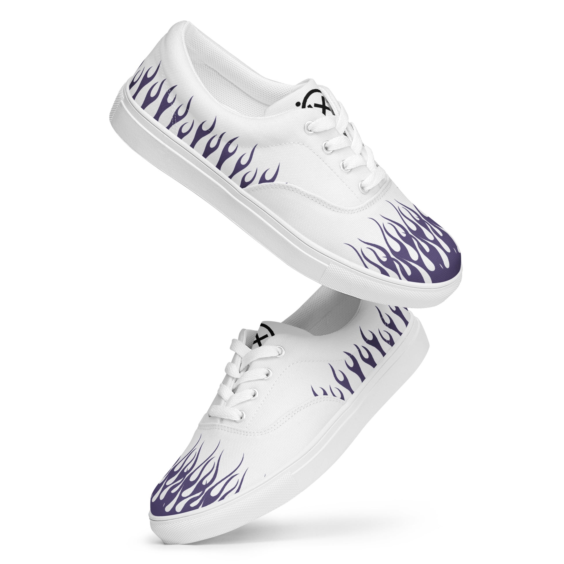 White canvas low-top sneakers with purple flame print and white laces.