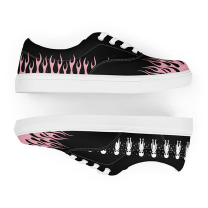 Black low-top sneakers with pink flame side panel, white midsole, character-print outsole