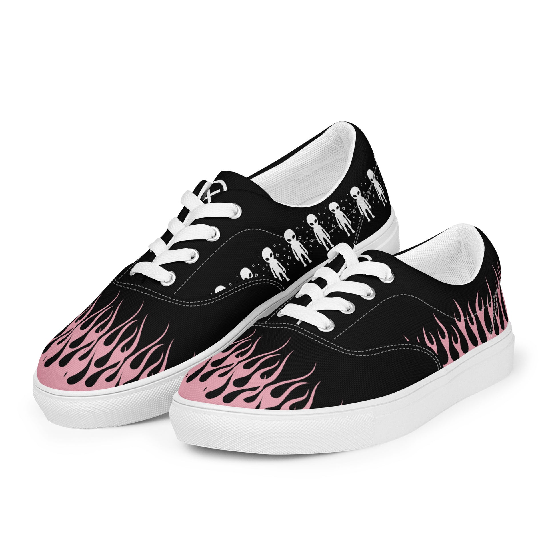 Black canvas sneaker pair with pink flame and alien graphics, white laces