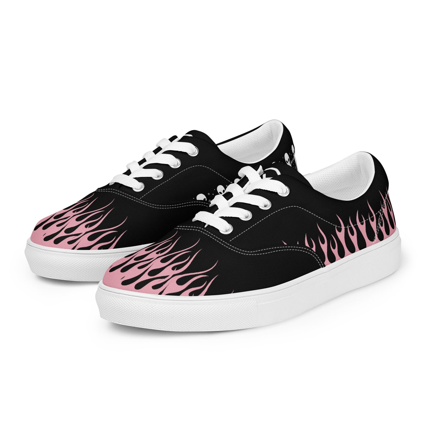 Black canvas low-top sneaker pair with pink flame graphics and white rubber outsole