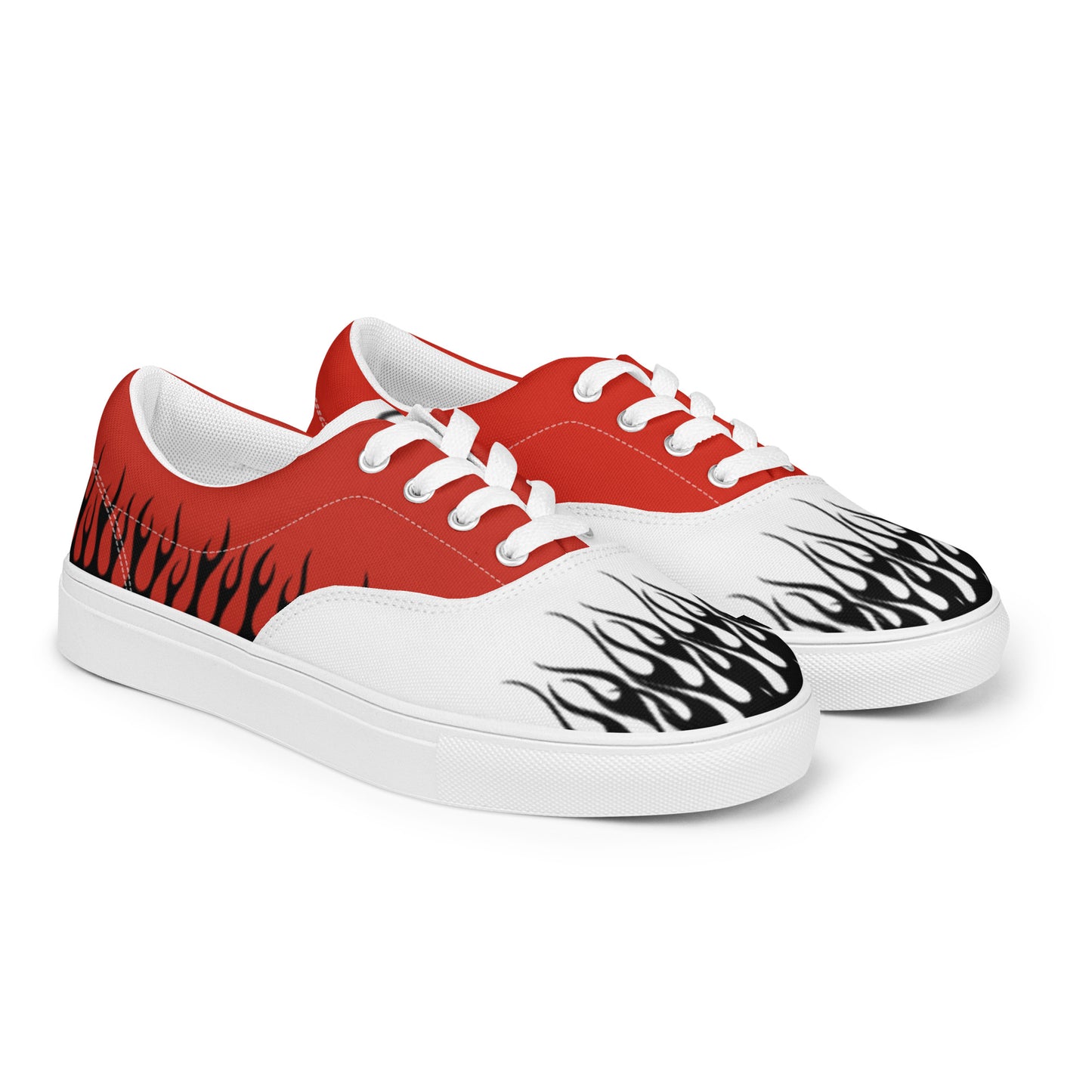 Red canvas low-top sneakers with white laces and black flame graphics on white toe panels