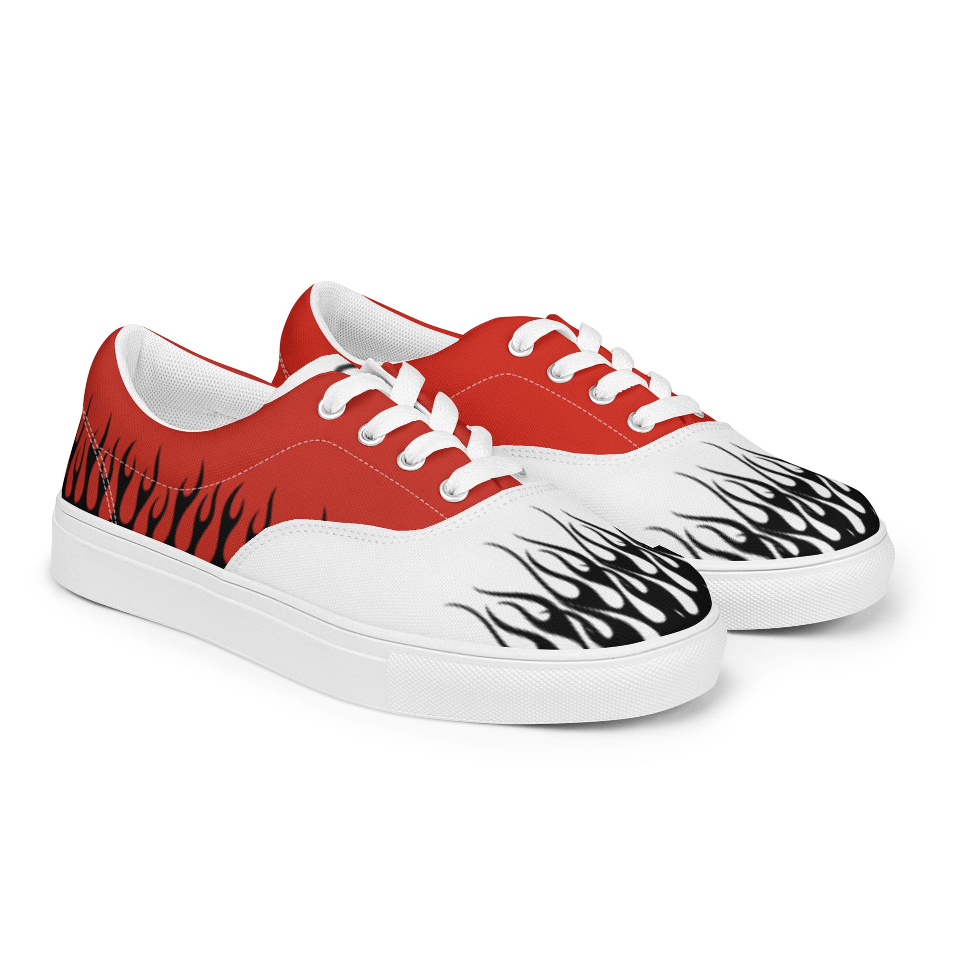 Red canvas low-top sneakers with white laces and black flame graphics on white toe panels