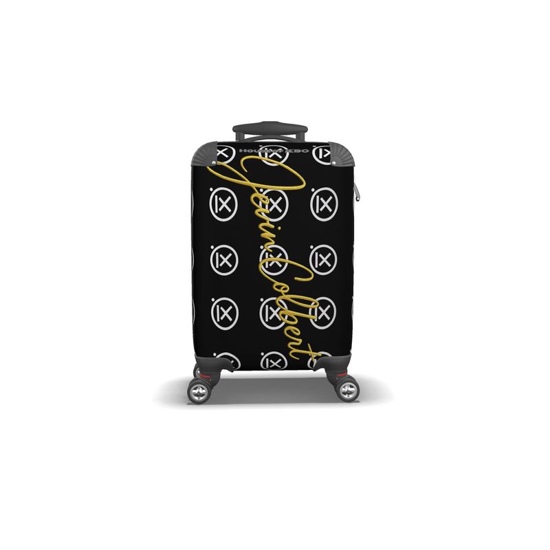 Hardshell suitcase, black with yellow lace-style graphics and repeating logo pattern; spinner wheels