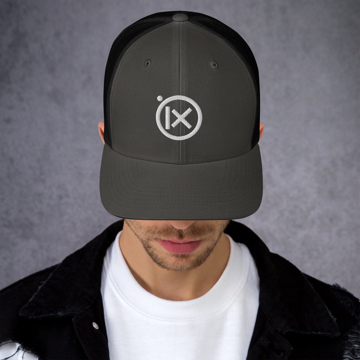 Black trucker snapback hat with white logo patch and mesh side panels