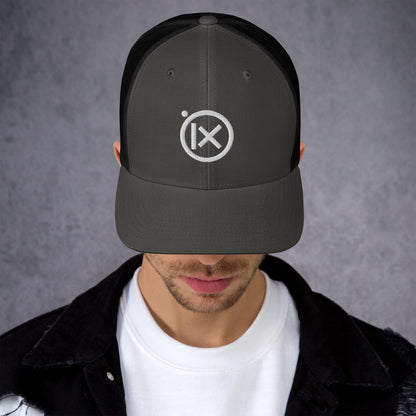 Black trucker snapback hat with white logo patch and mesh side panels