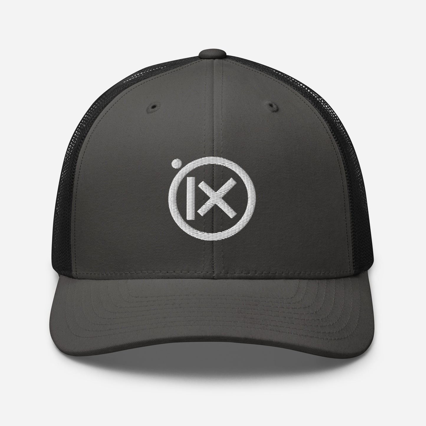 Trucker snapback cap with dark gray front panel, black mesh back, and white logo
