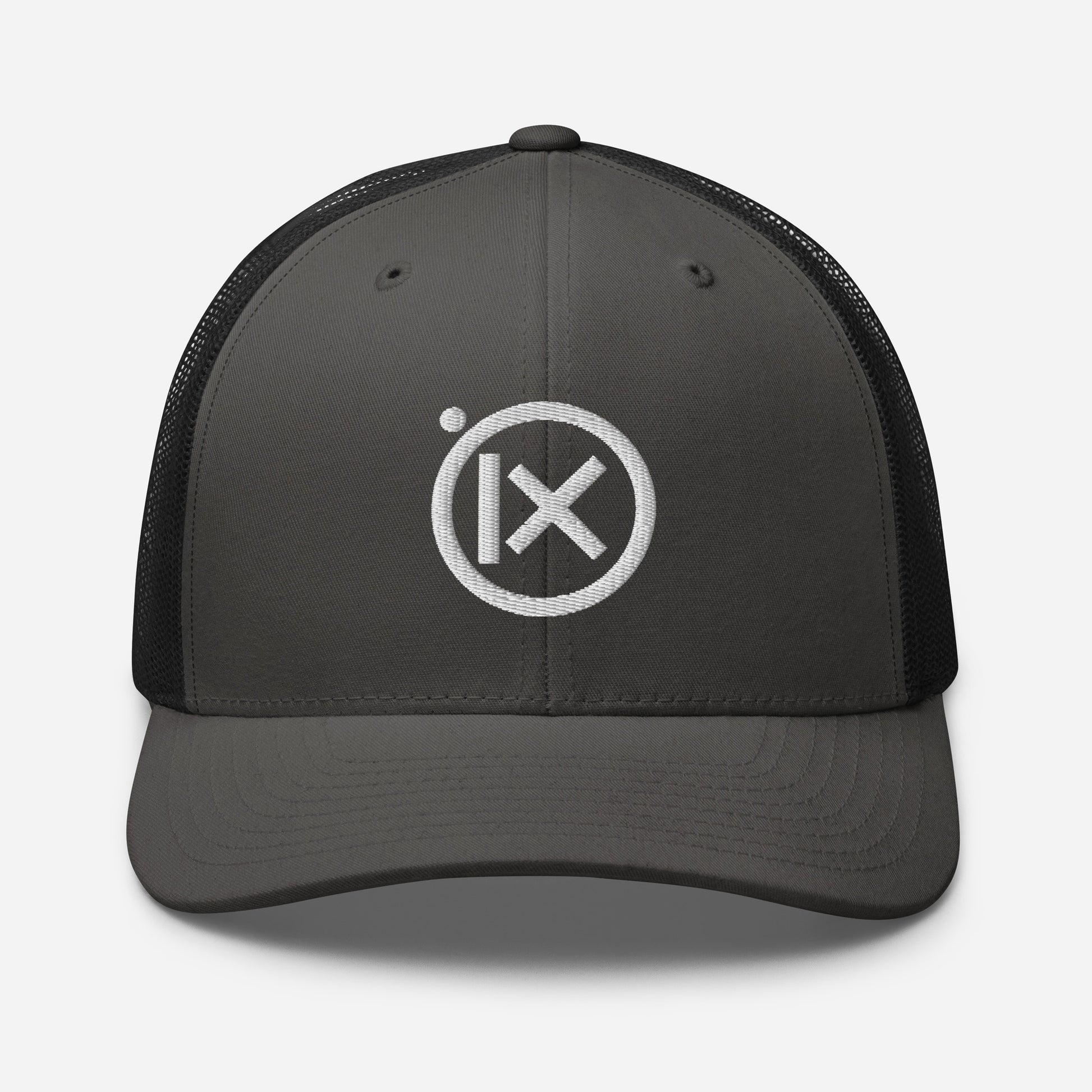 Trucker snapback cap with dark gray front panel, black mesh back, and white logo