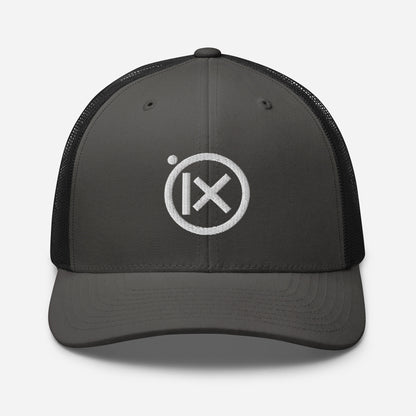Trucker snapback cap with dark gray front panel, black mesh back, and white logo