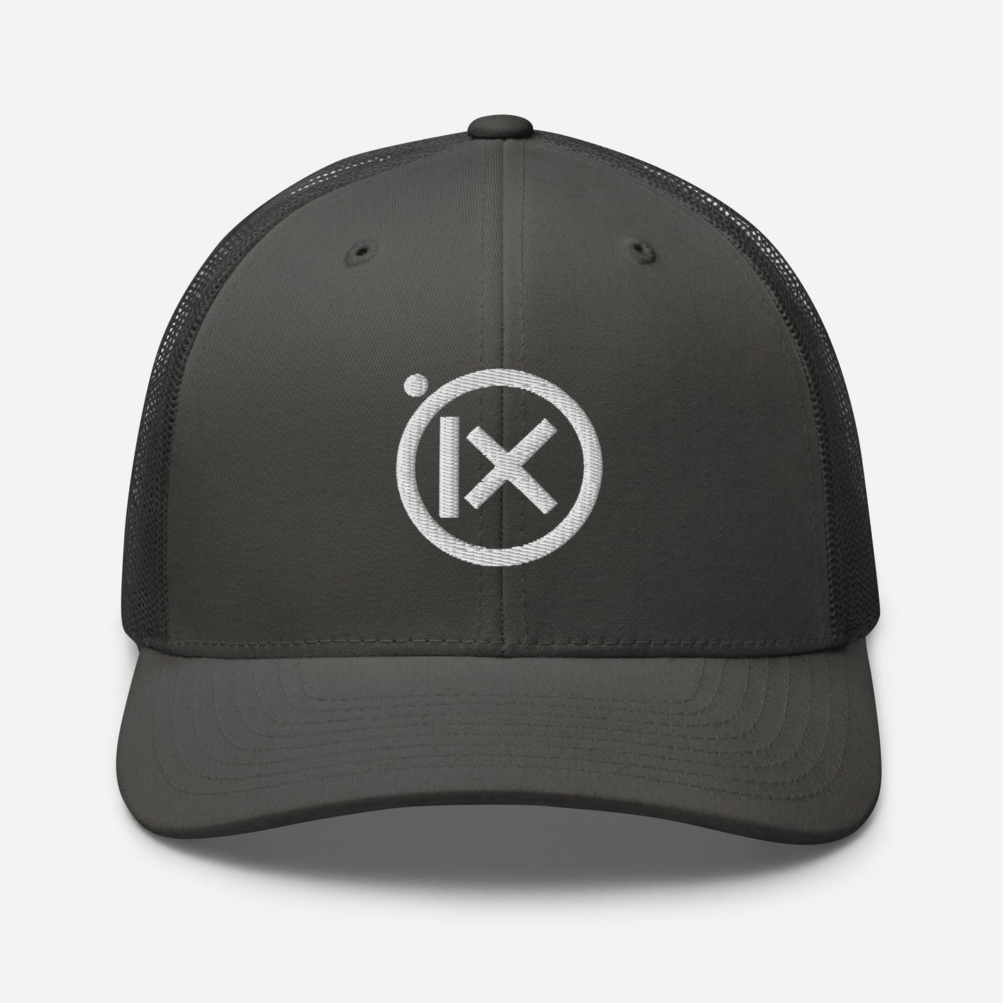 Trucker snapback cap with dark gray front, black mesh back, and white logo patch