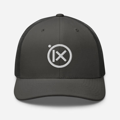 Trucker snapback cap with dark gray front, black mesh back, and white logo patch