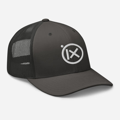 Trucker snapback cap with dark crown, black mesh sides, and circular white logo