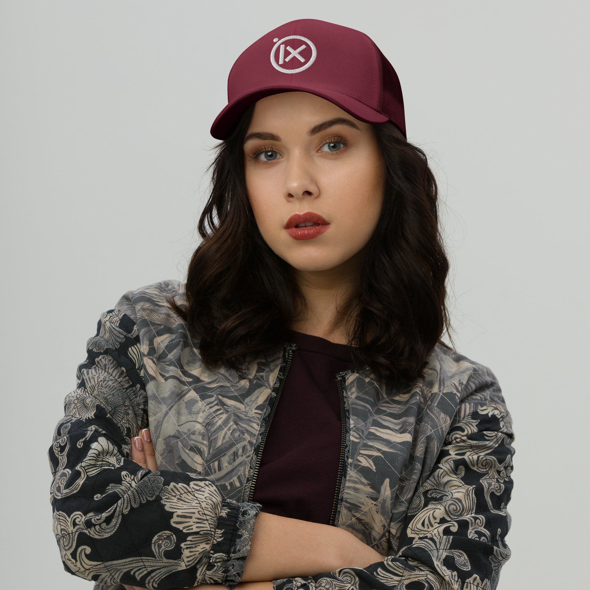 Retro trucker snapback cap in cranberry red with mesh back and circular logo emblem