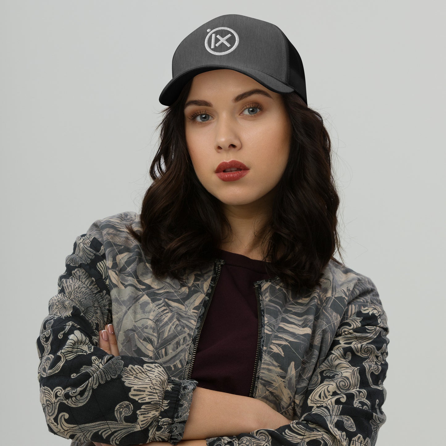 Heather gray trucker snapback hat with white logo patch, curved brim