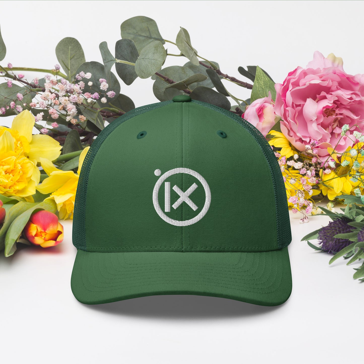 Green trucker snapback hat with white logo patch and mesh back