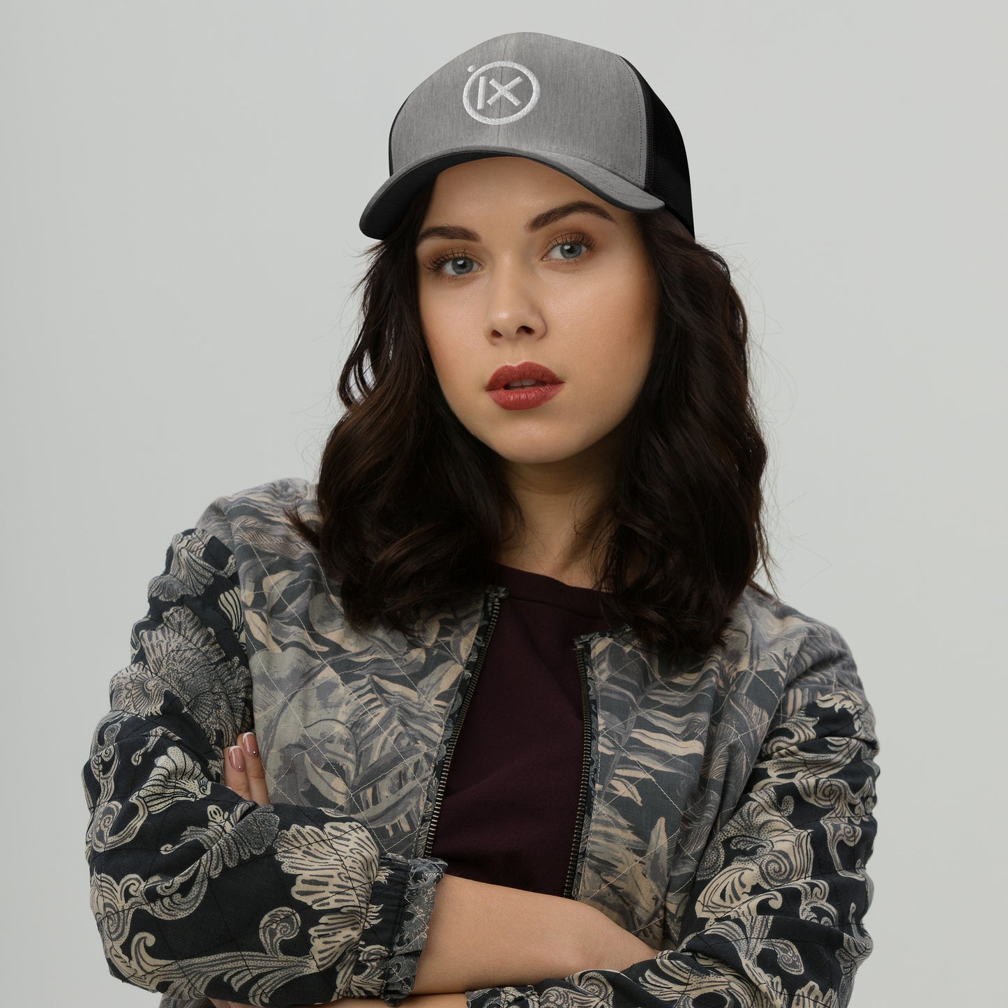 Heather gray trucker snapback hat with white logo patch and black mesh back
