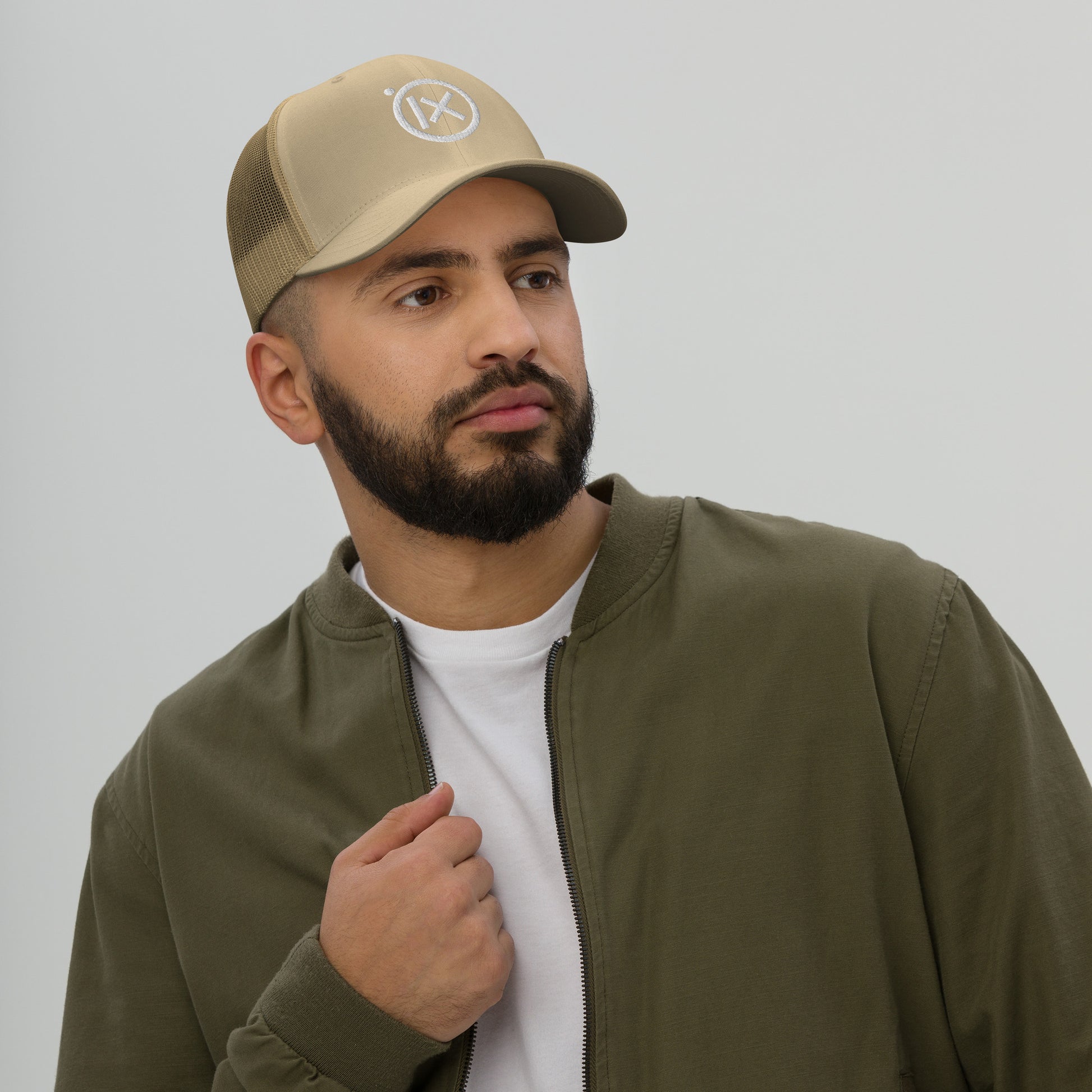 Beige mesh trucker snapback cap with white X logo patch on front
