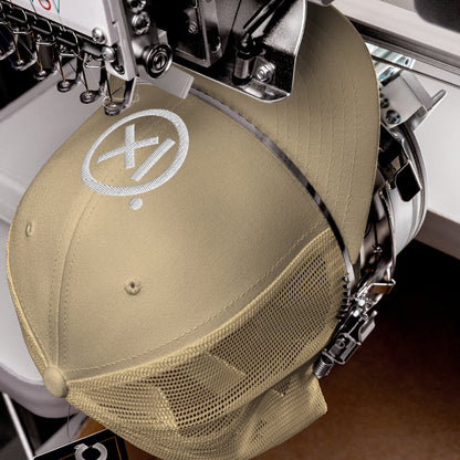Retro trucker snapback cap in khaki with mesh side panels and circular logo patch