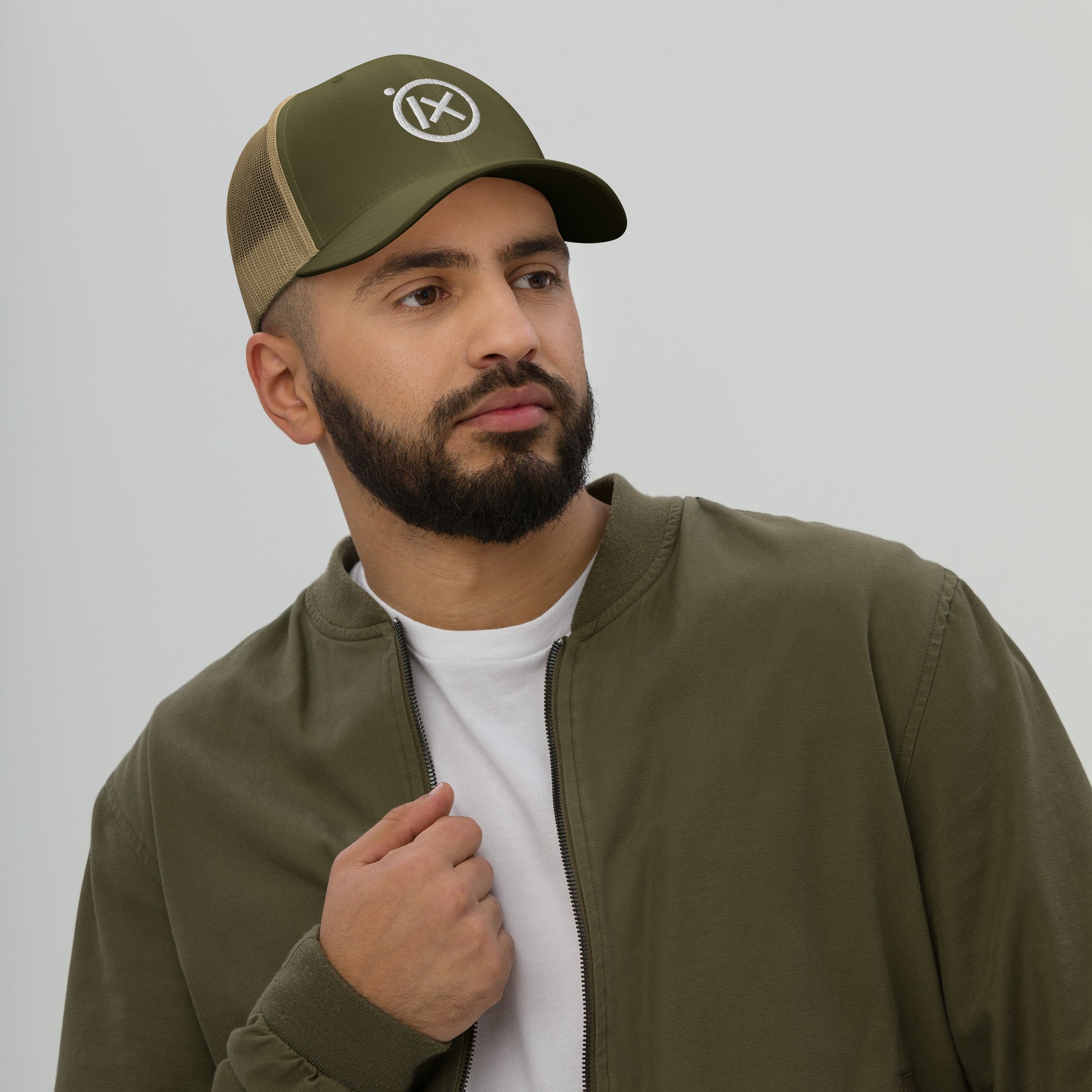 Retro trucker snapback cap in olive green with mesh back and circular logo emblem