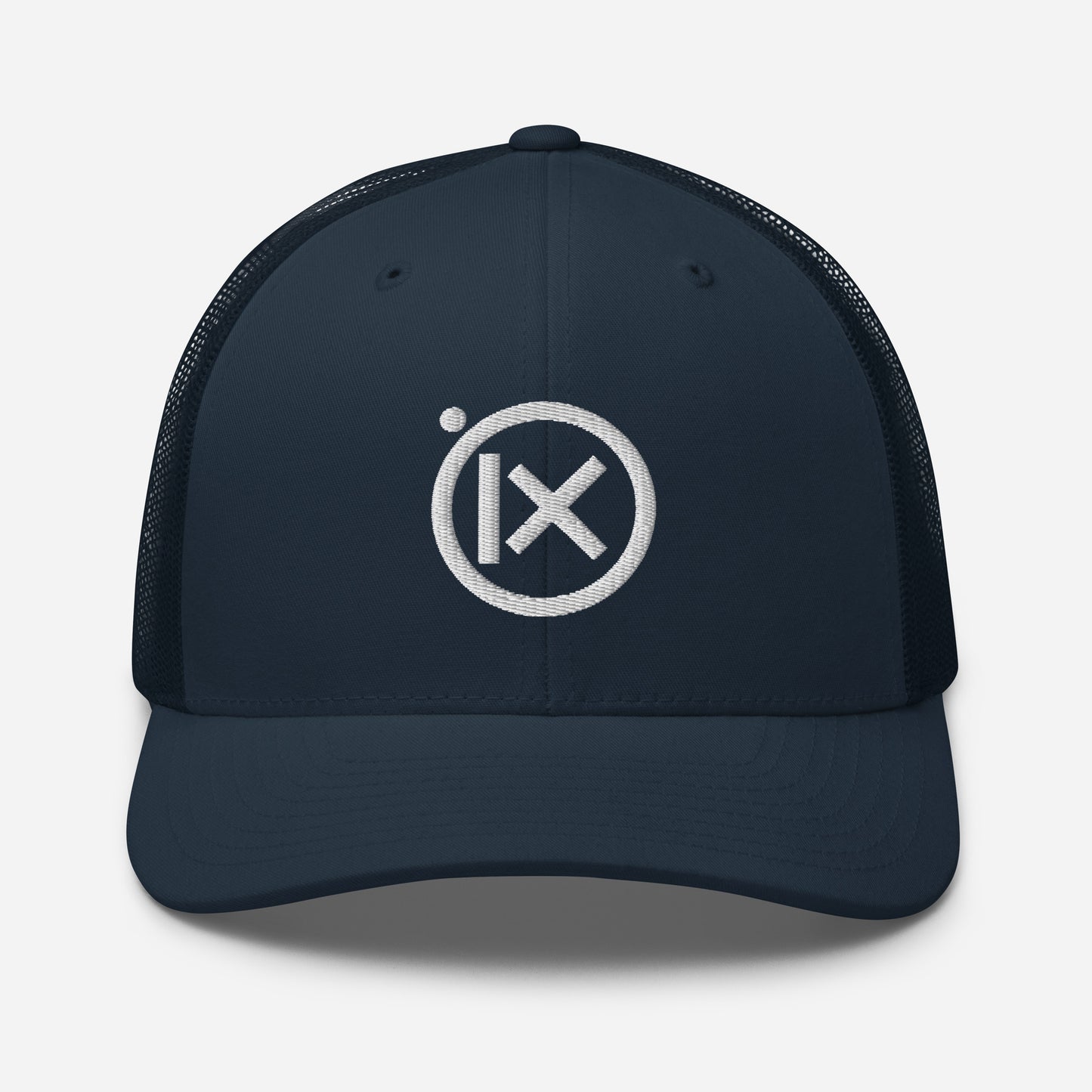Trucker snapback cap in dark navy with white circular logo badge and matching brim