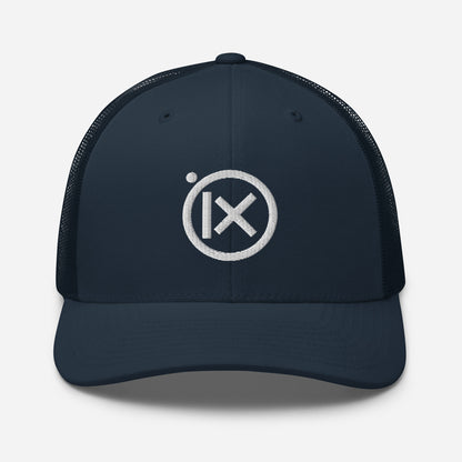 Trucker snapback cap in dark navy with white circular logo badge and matching brim