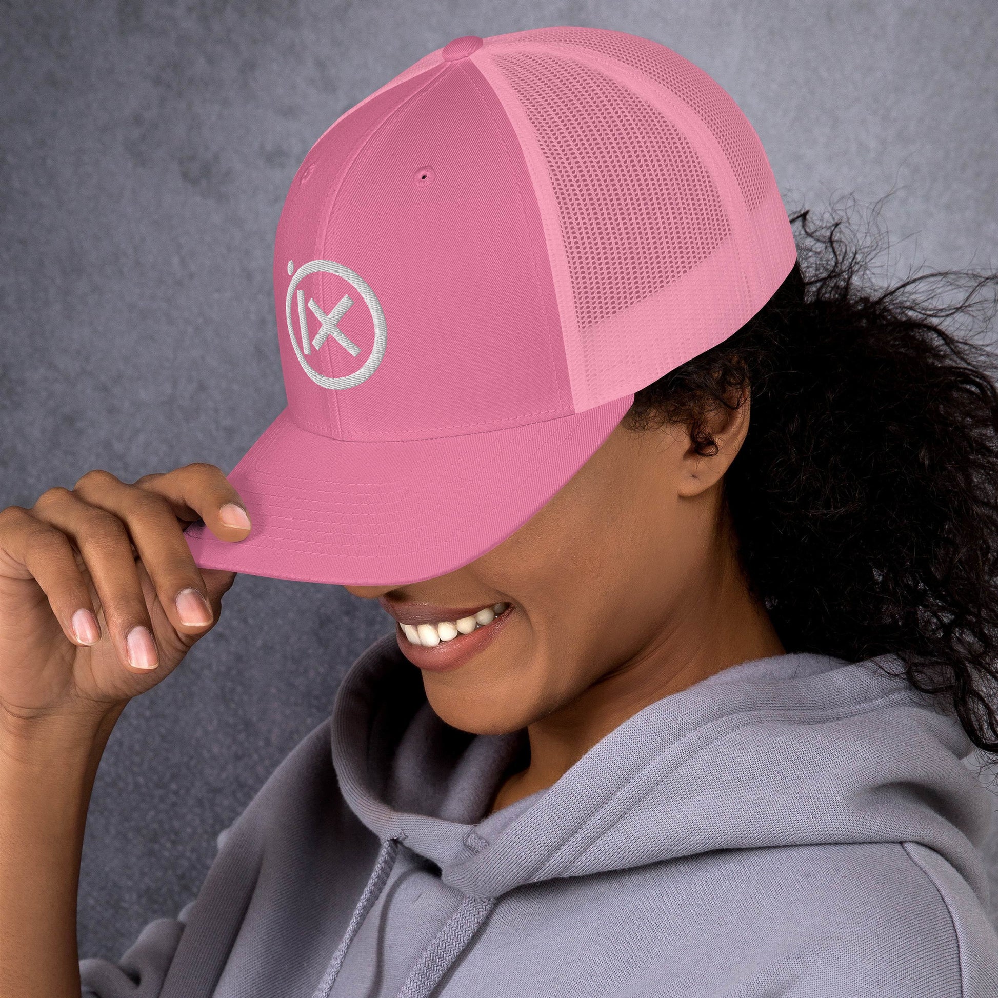 Trucker snapback hat in pink with white logo patch and mesh panels