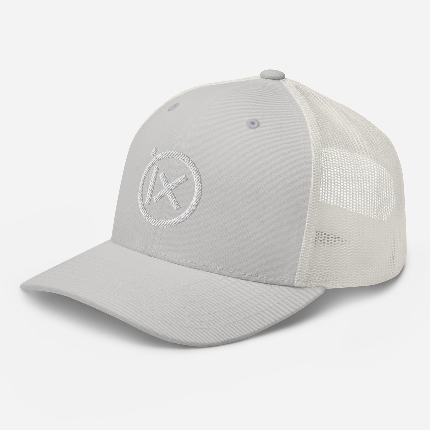 White trucker snapback cap with circular X logo patch and white mesh side panels.
