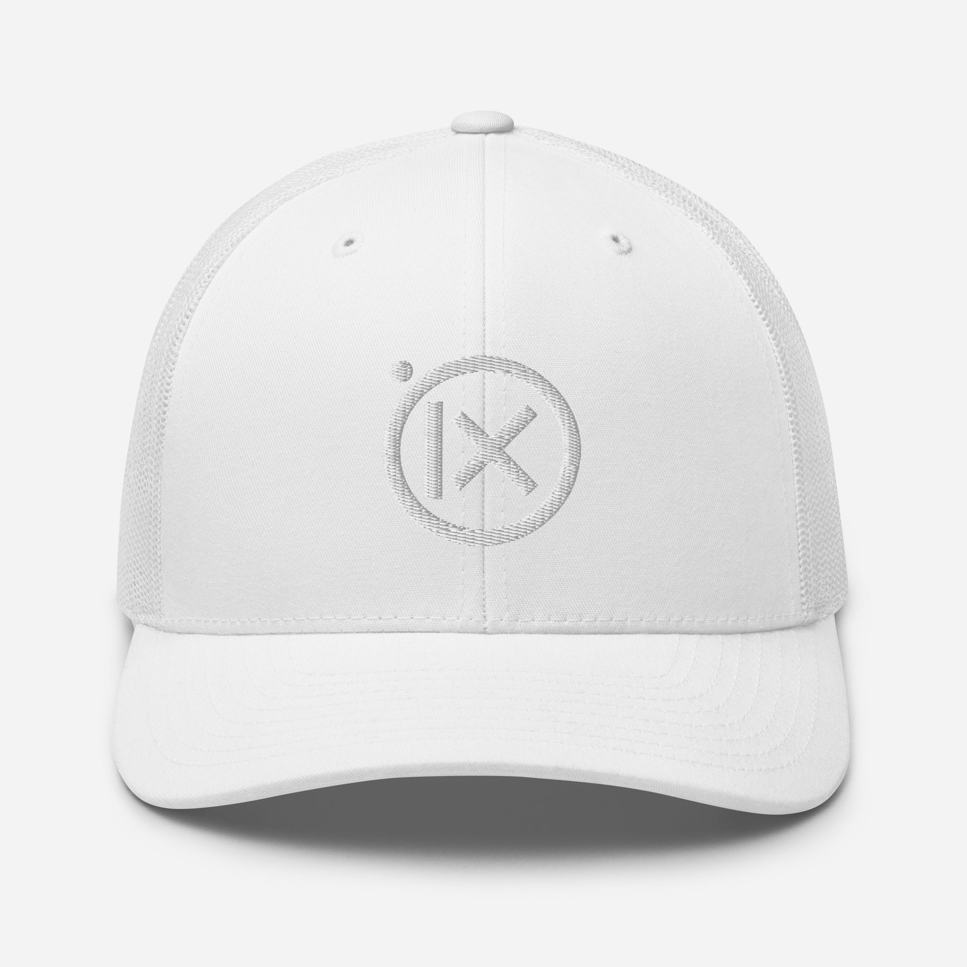 White trucker snapback cap with circular X logo patch on front